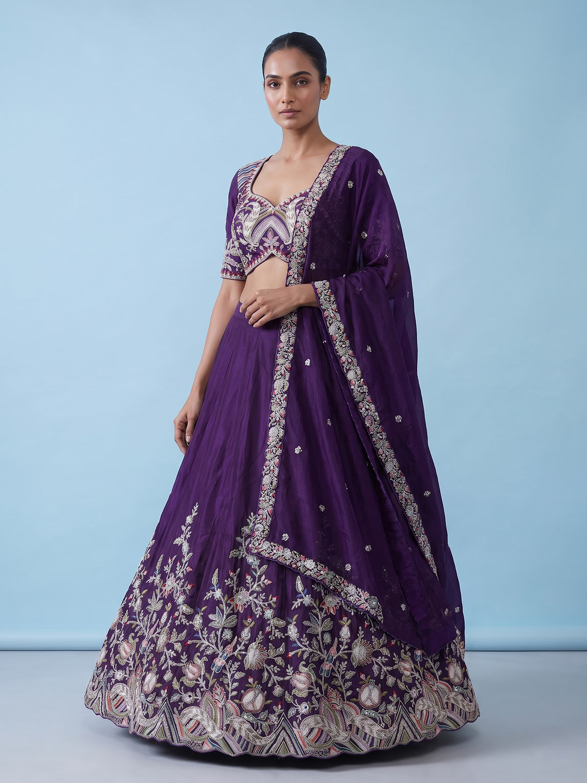 Royal purple silk lehenga choli with intricate festive craftsmanship
