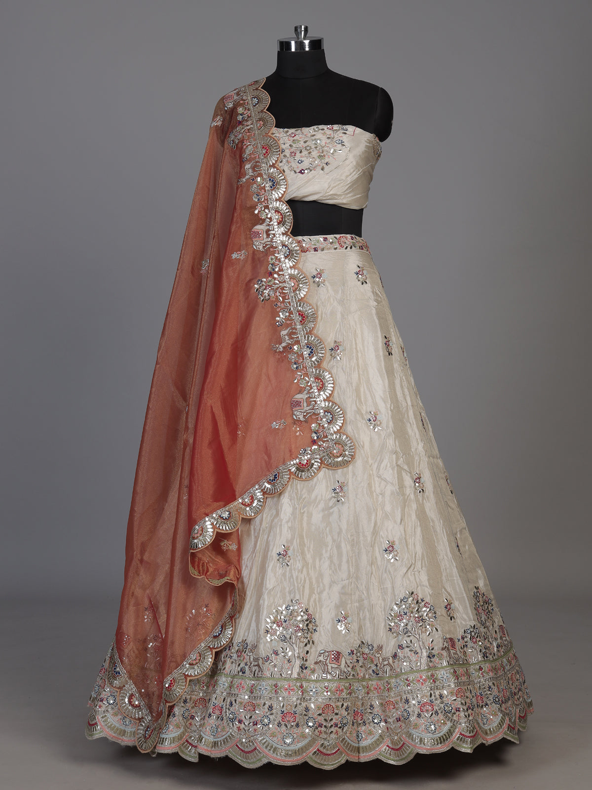 Cream silk lehenga choli decorated with charming animal motifs