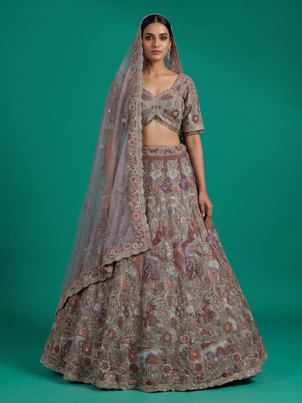 Grey silk lehenga choli with ornate floral and animal motifs