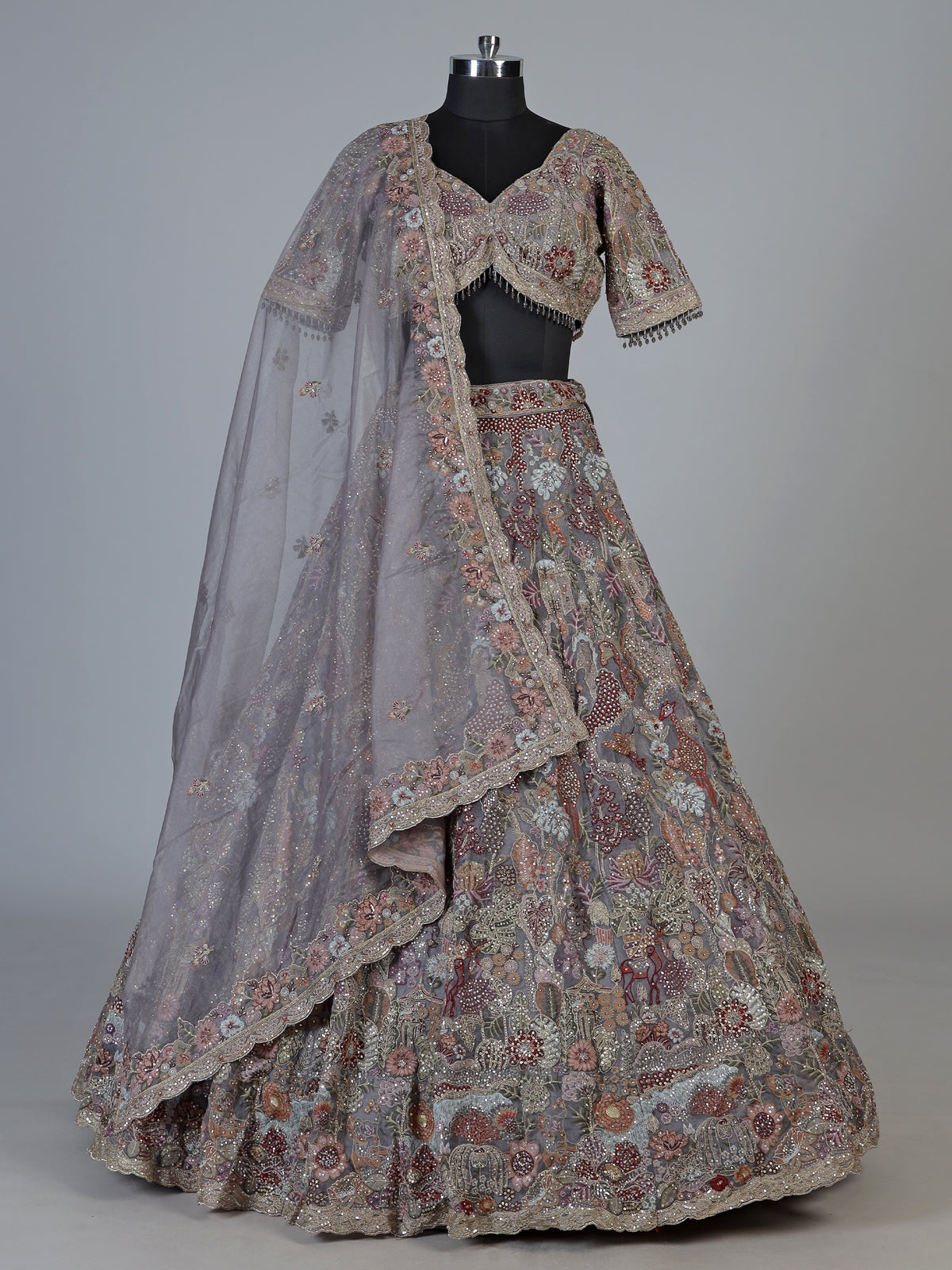 Grey silk lehenga choli with ornate floral and animal motifs