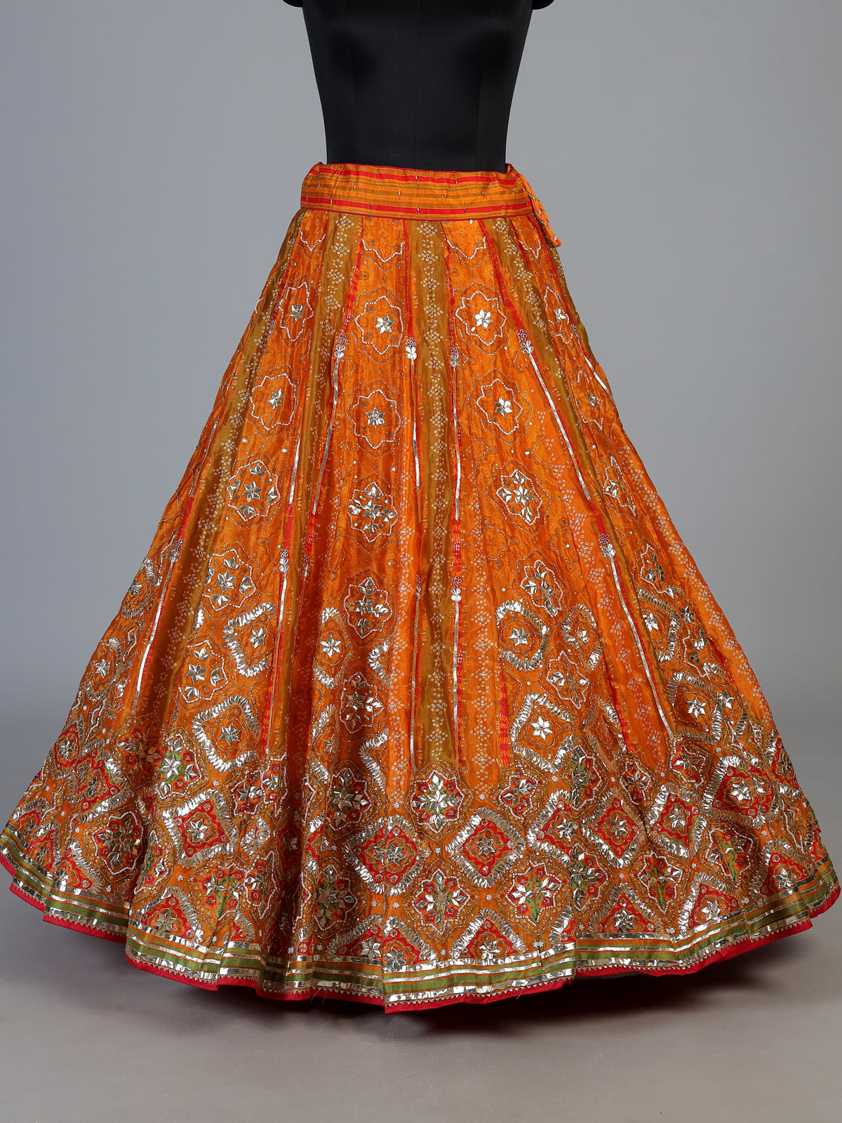 Orange silk unstitched lehenga choli with bandhani elegance