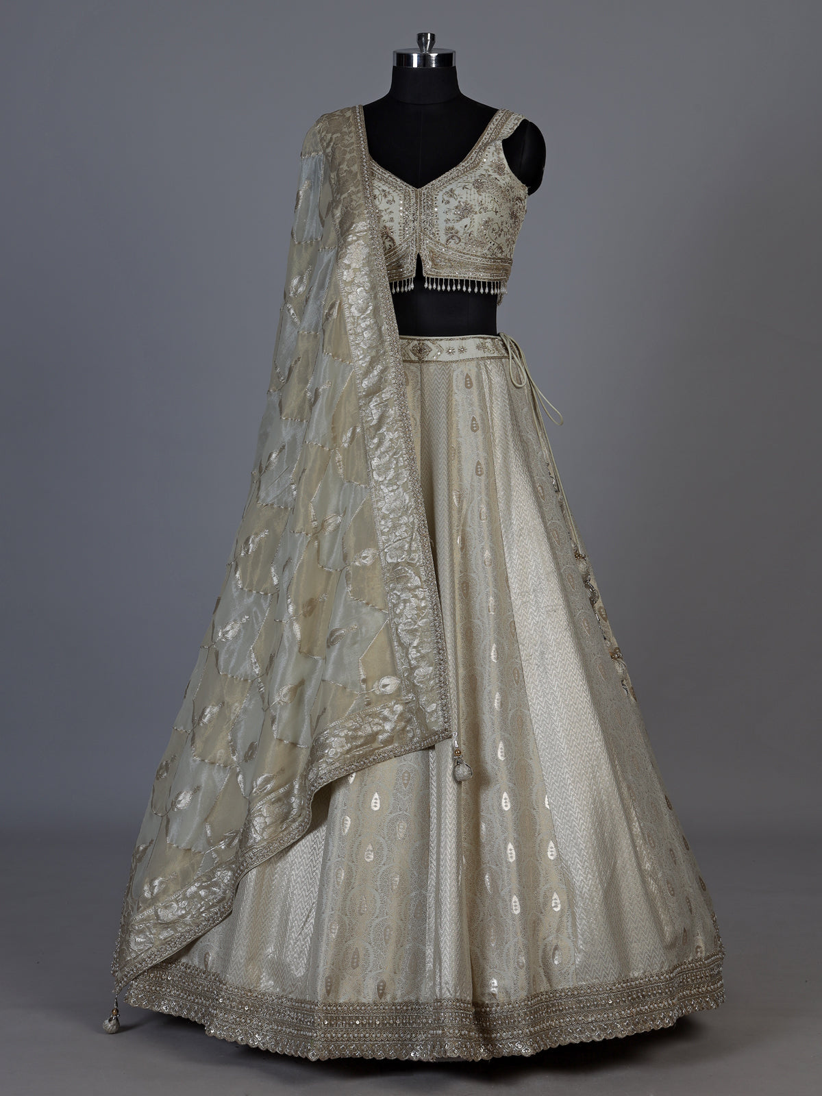Cream jacquard brocade lehenga choli with lavish embellishments