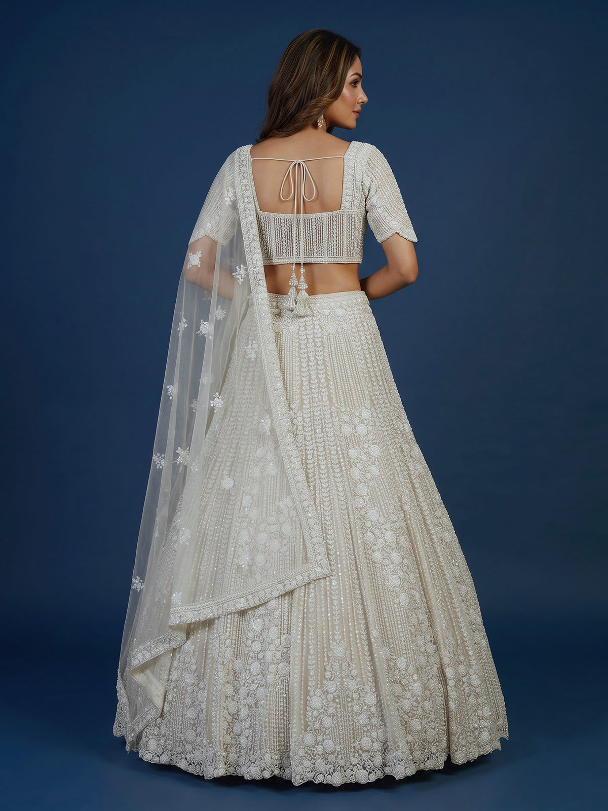 White net lehenga choli with delicate cutdana sequins detailing