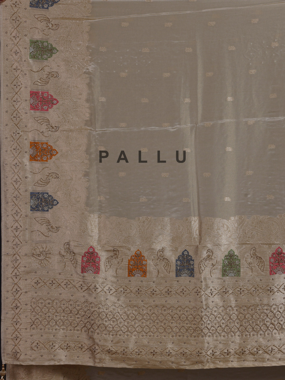 Pastel beige silk saree with delicate traditional embellishments