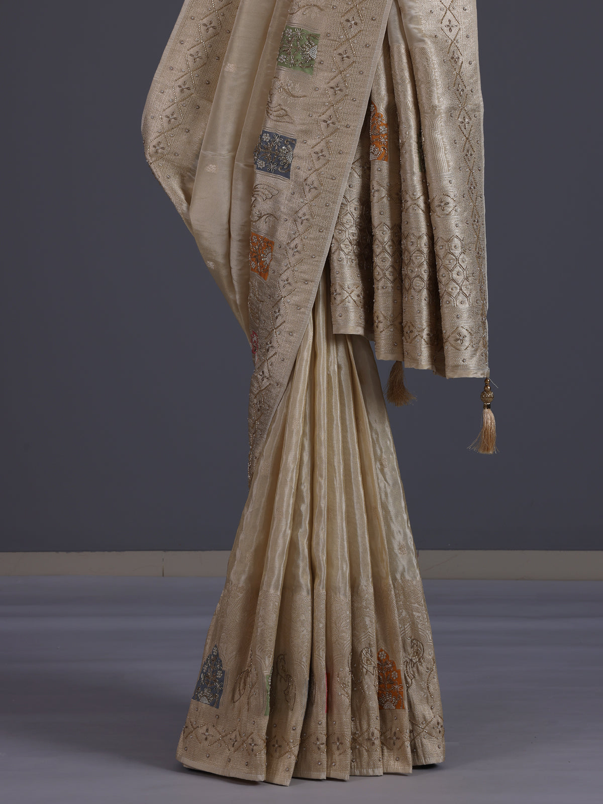 Pastel beige silk saree with delicate traditional embellishments