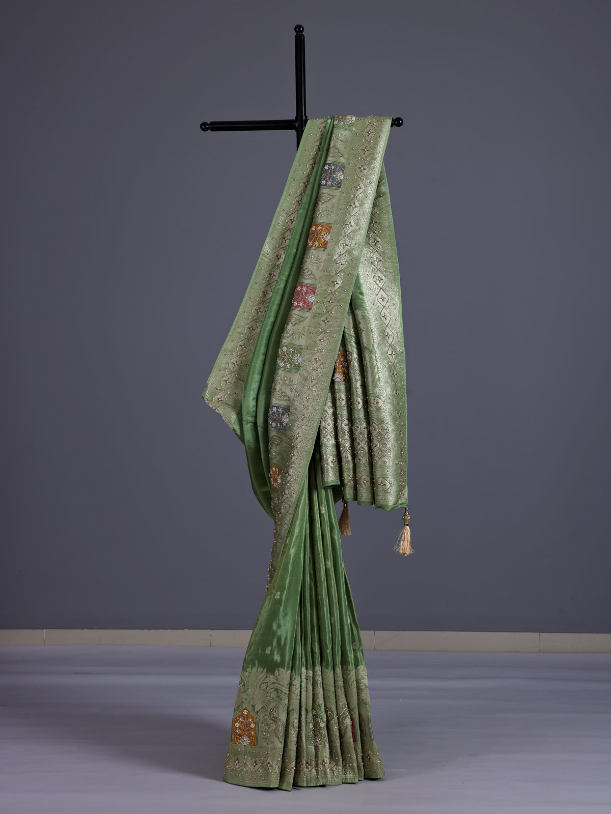 Pista green silk saree with elegant peacock motif embellishments