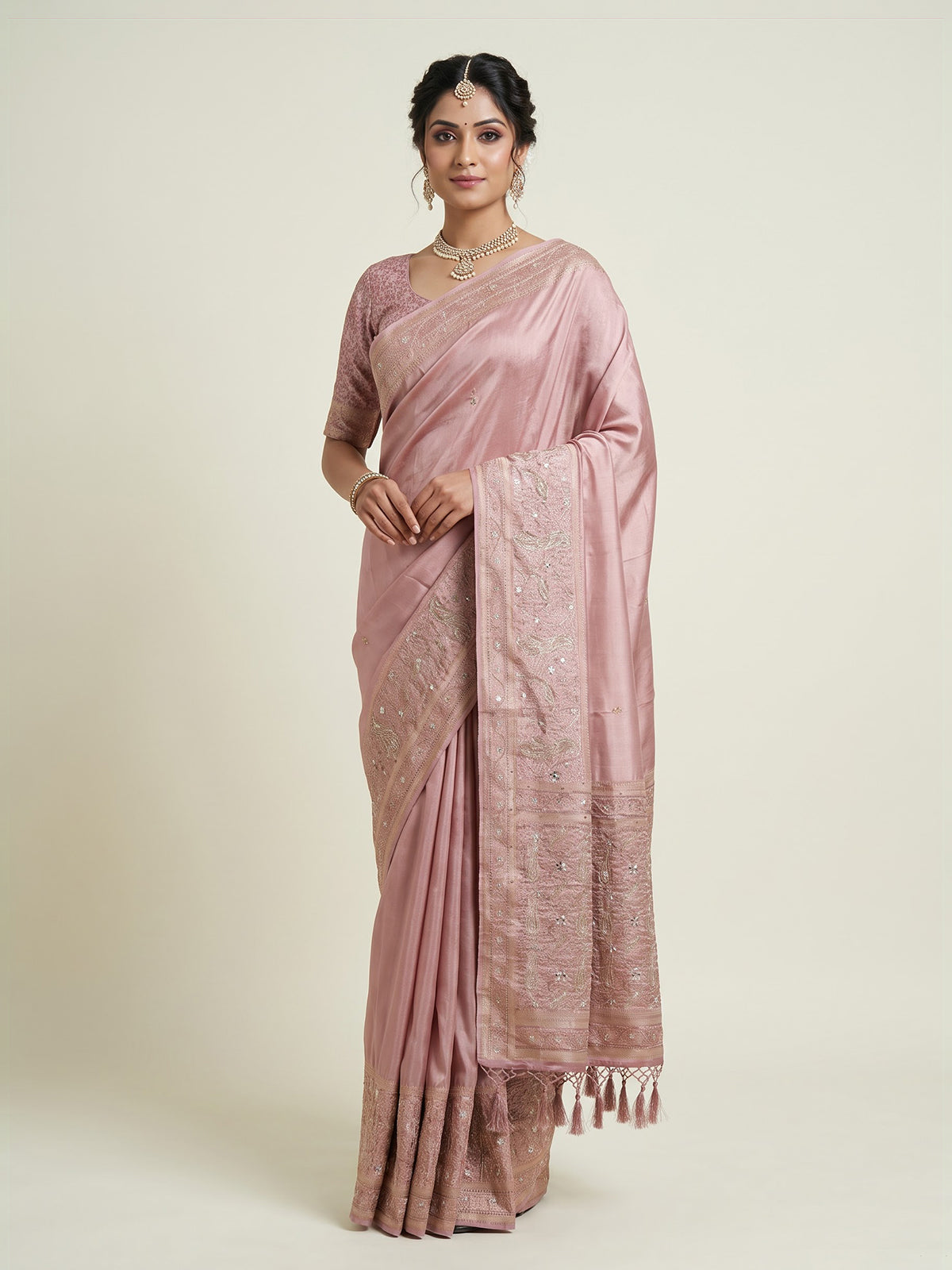 Onion pink silk saree with graceful traditional pallu tassels