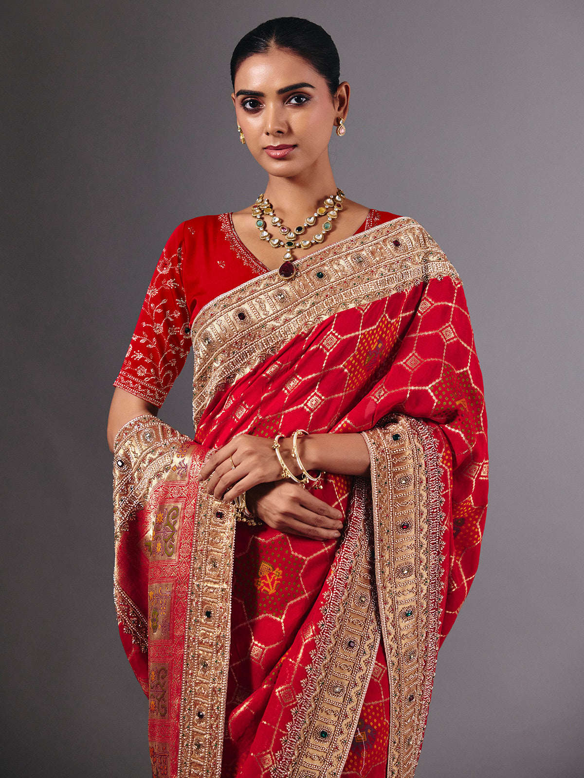 Radiant red georgette saree with zari animal motif embellishments