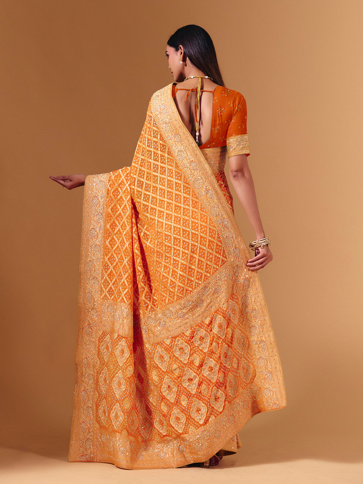 Orange georgette saree with bandhani print and zardosi embellishments