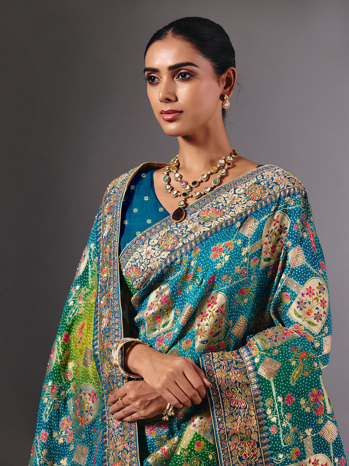 Blue dola silk saree with elegant peacock motif embellishments