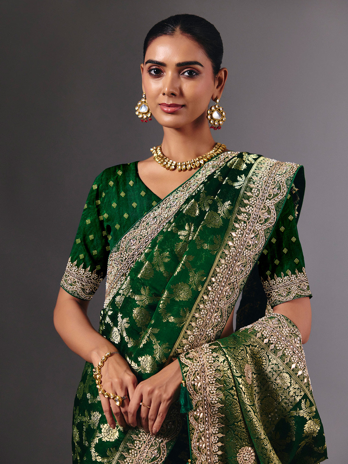 Green satin silk saree with ornate zari tassel detailing