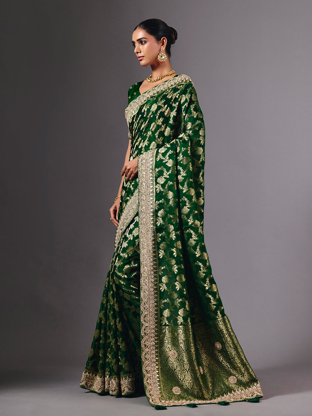 Green satin silk saree with ornate zari tassel detailing
