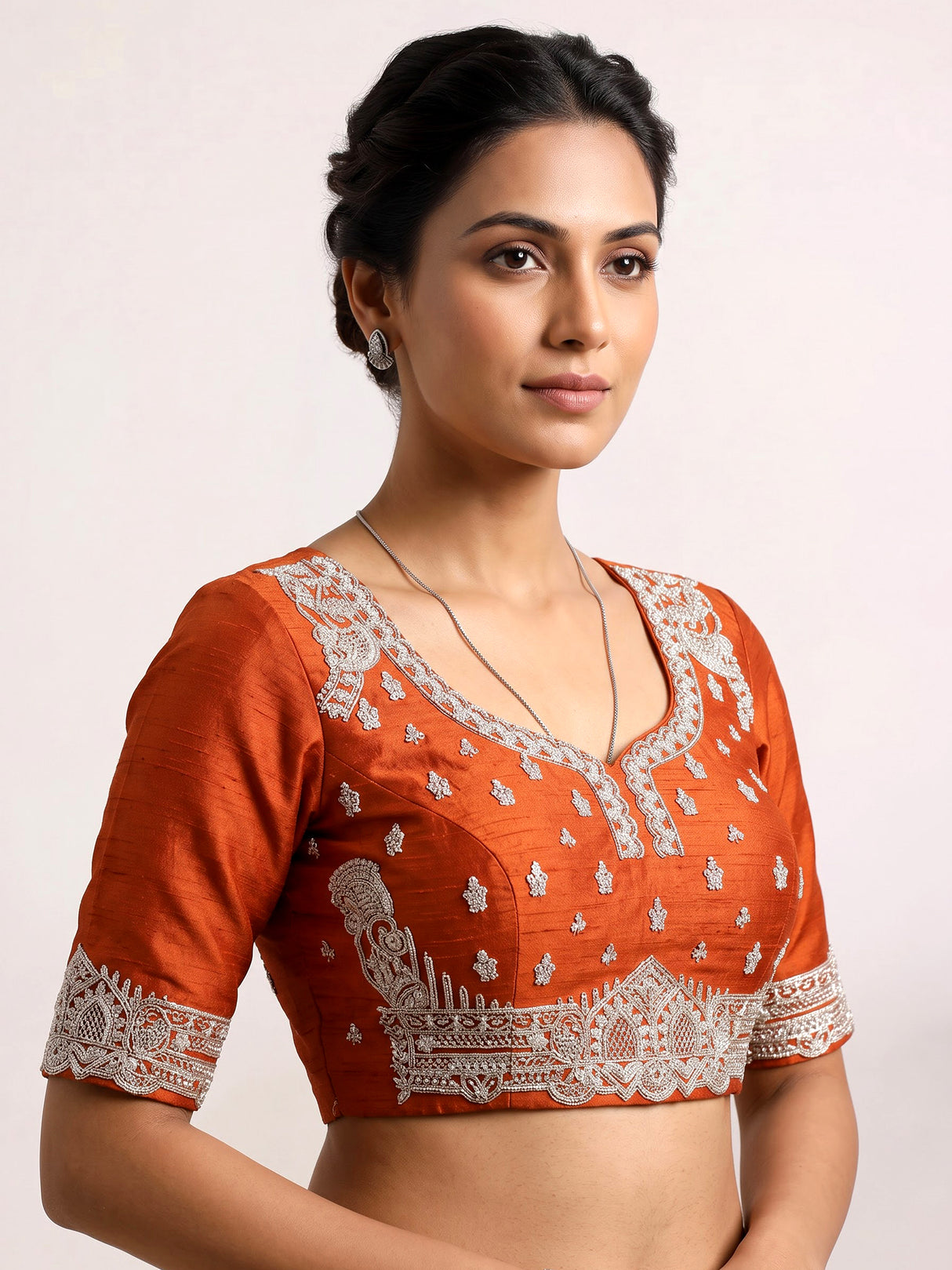 Rust orange raw silk unstitched lehenga choli with ornate butti detailing
