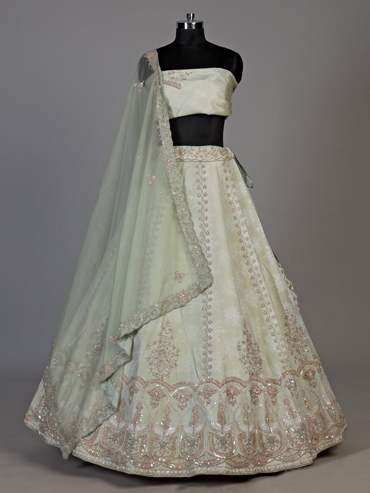 Mint green silk unstitched lehenga choli with intricate zari elegance