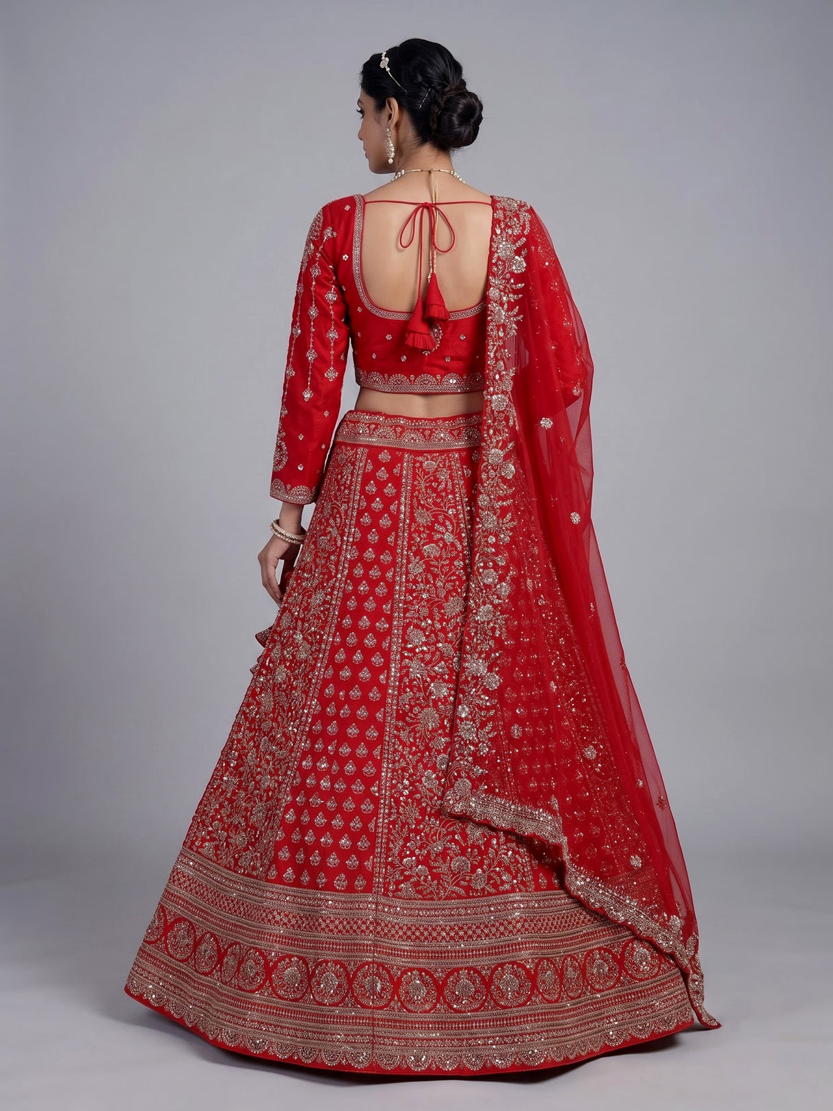 Red silk lehenga choli with exquisite resham and cutdana detailing
