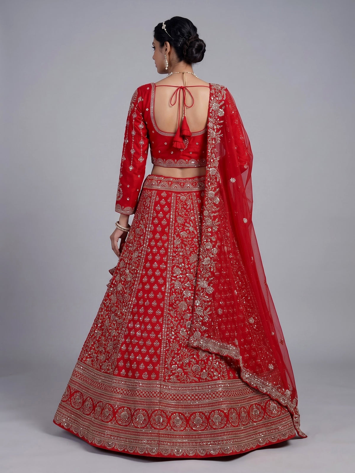 Red silk lehenga choli with exquisite resham and cutdana detailing