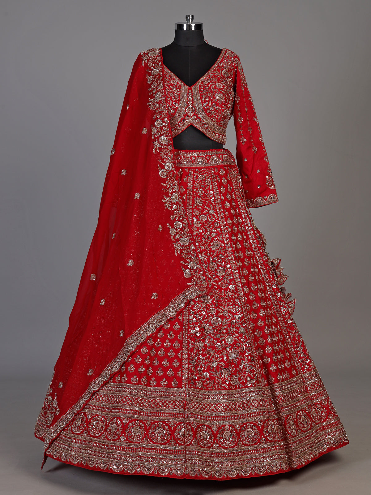 Red silk lehenga choli with exquisite resham and cutdana detailing