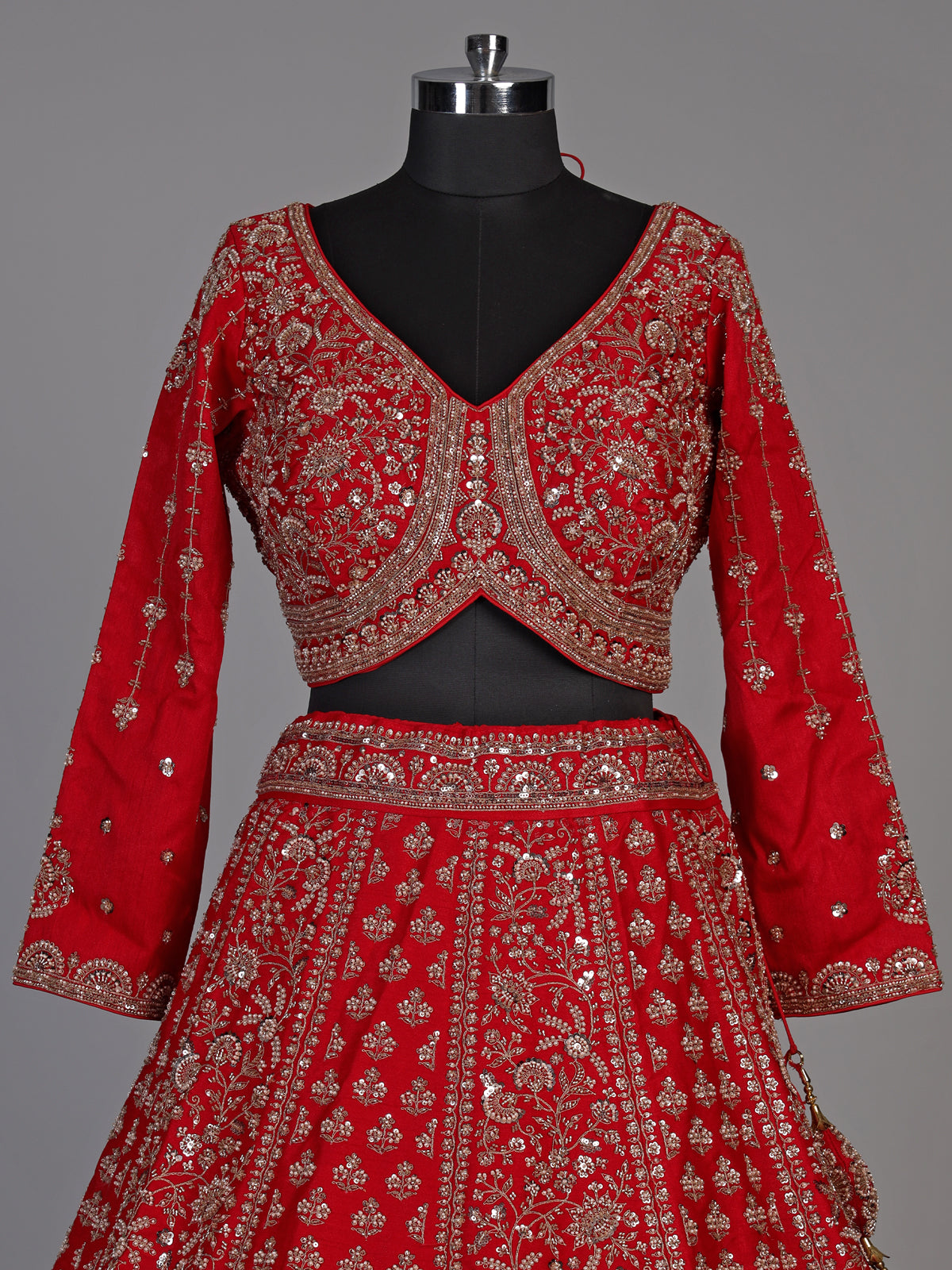 Red silk lehenga choli with exquisite resham and cutdana detailing