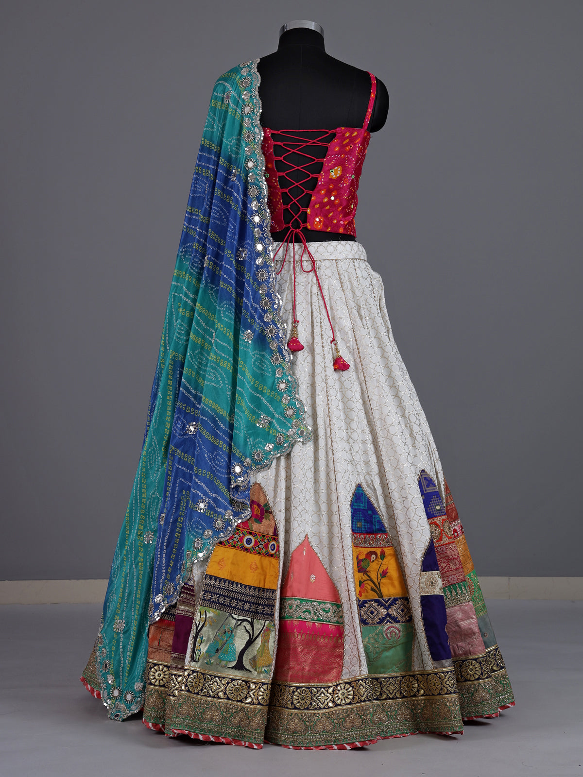 White silk blend lehenga choli with intricate traditional embellishments