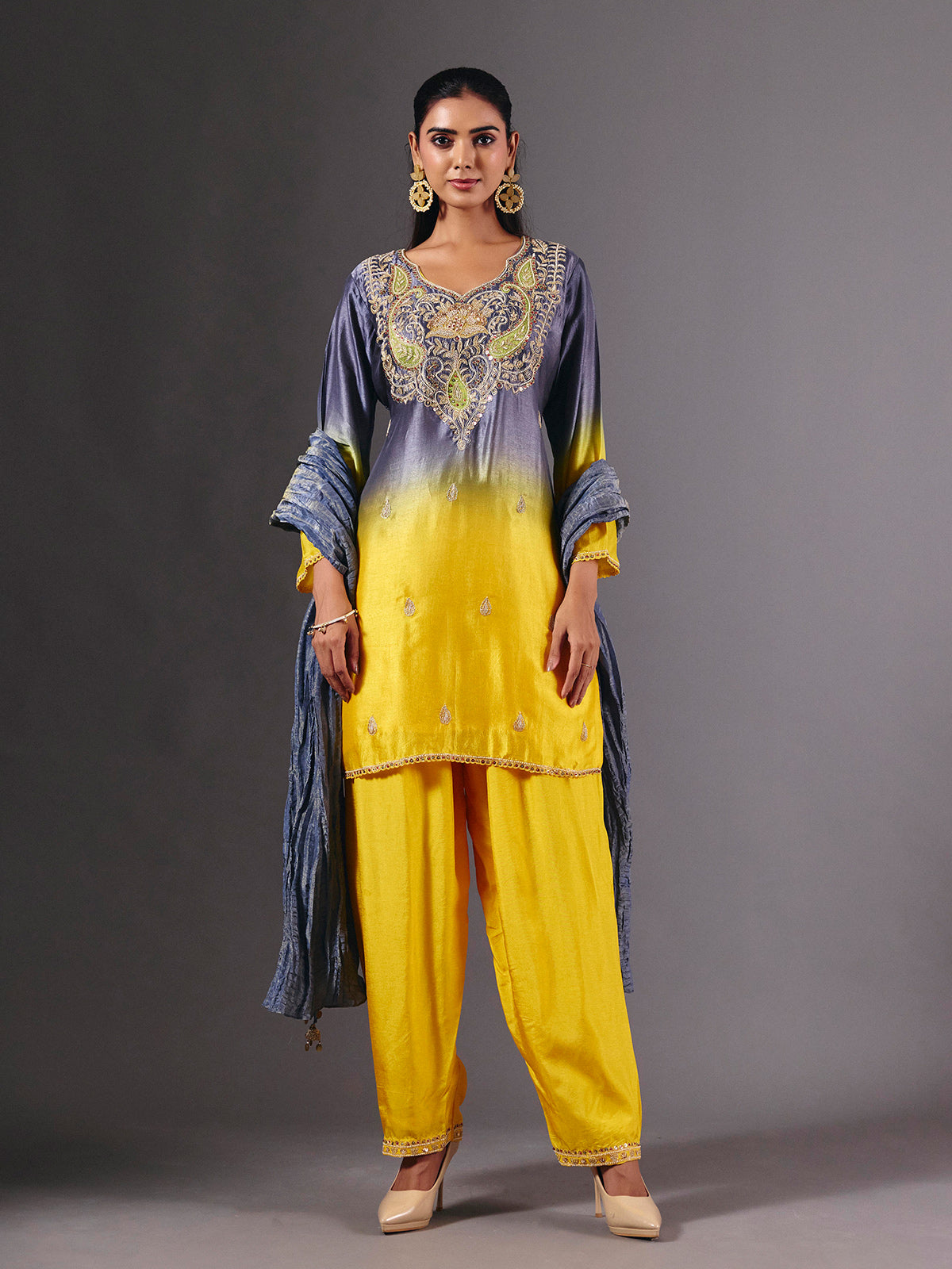 Yellow silk shaded salwar suit with purple dupatta and embellishments