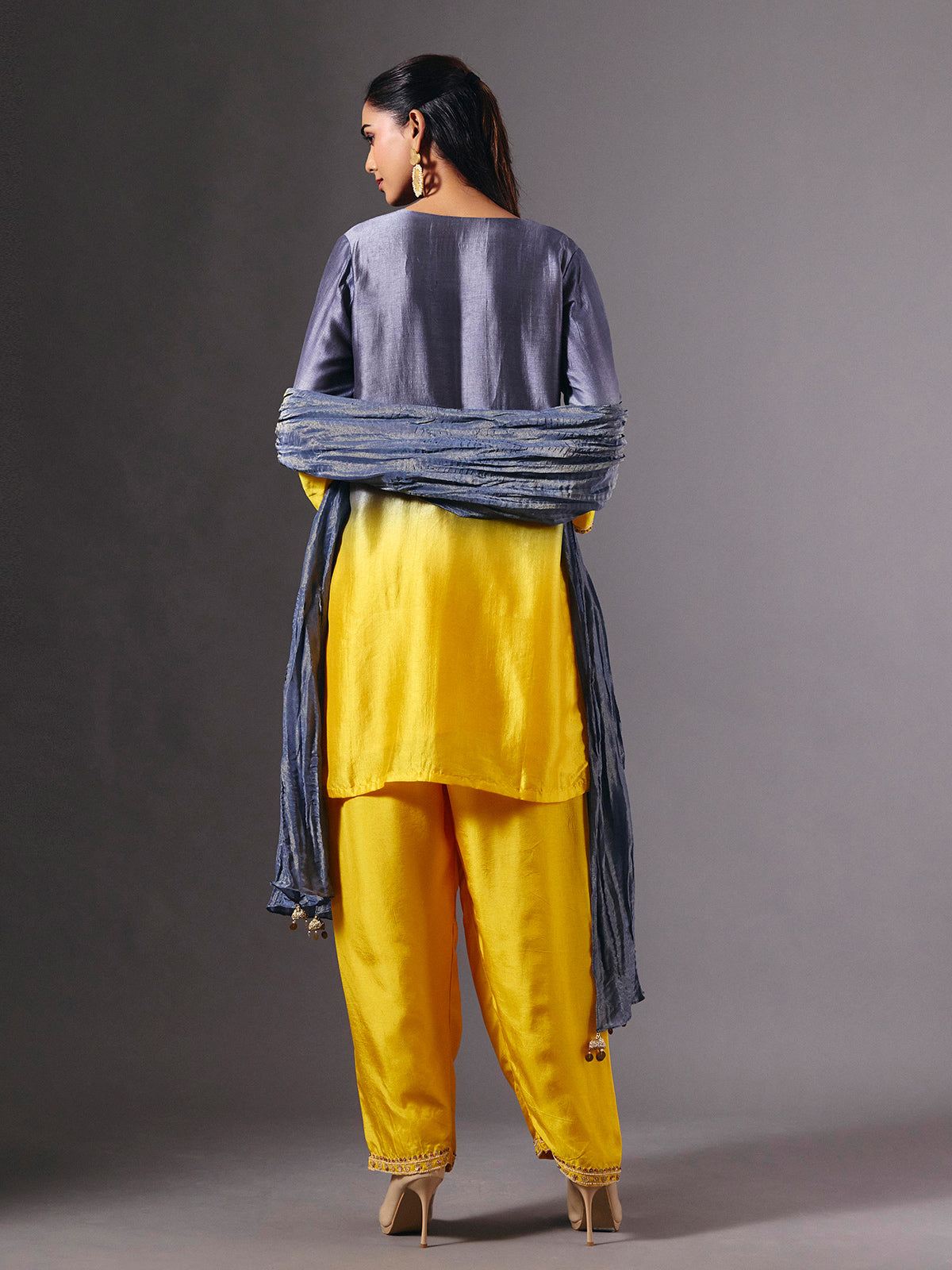 Yellow silk shaded salwar suit with purple dupatta and embellishments