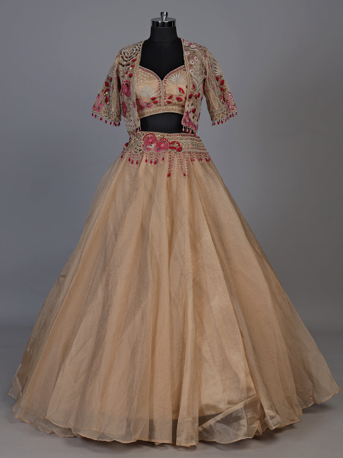 Beige organza tissue lehenga choli with embroidered jacket detailing