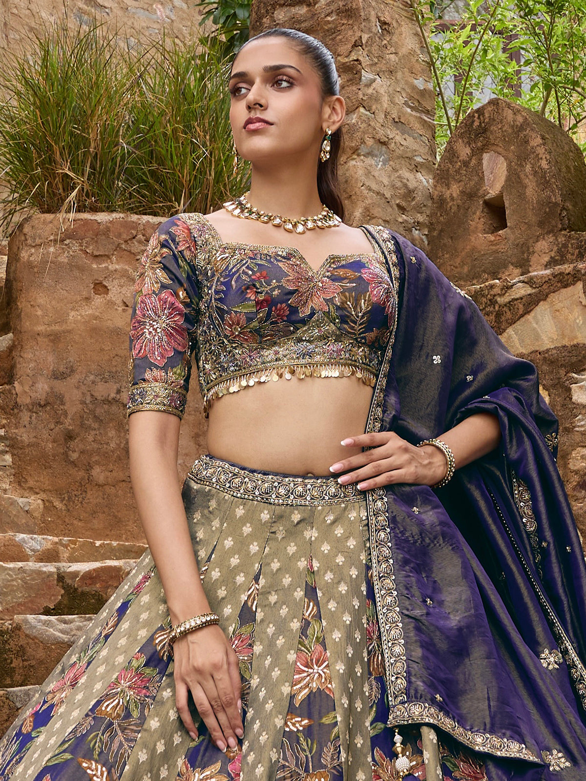 Blue silk lehenga choli with floral motifs and embellished dupatta