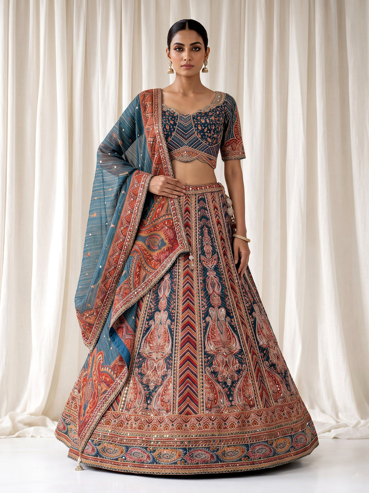 Teal blue lehenga choli with rust paisley detailing