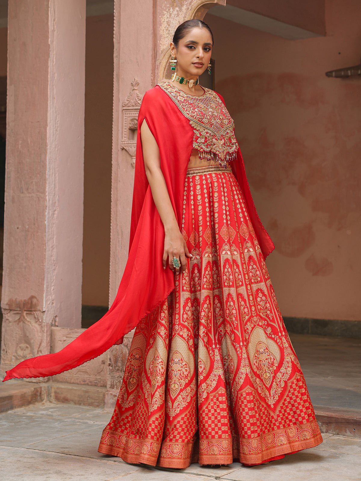 Red traditional printed lehenga choli with heavy work cape jacket
