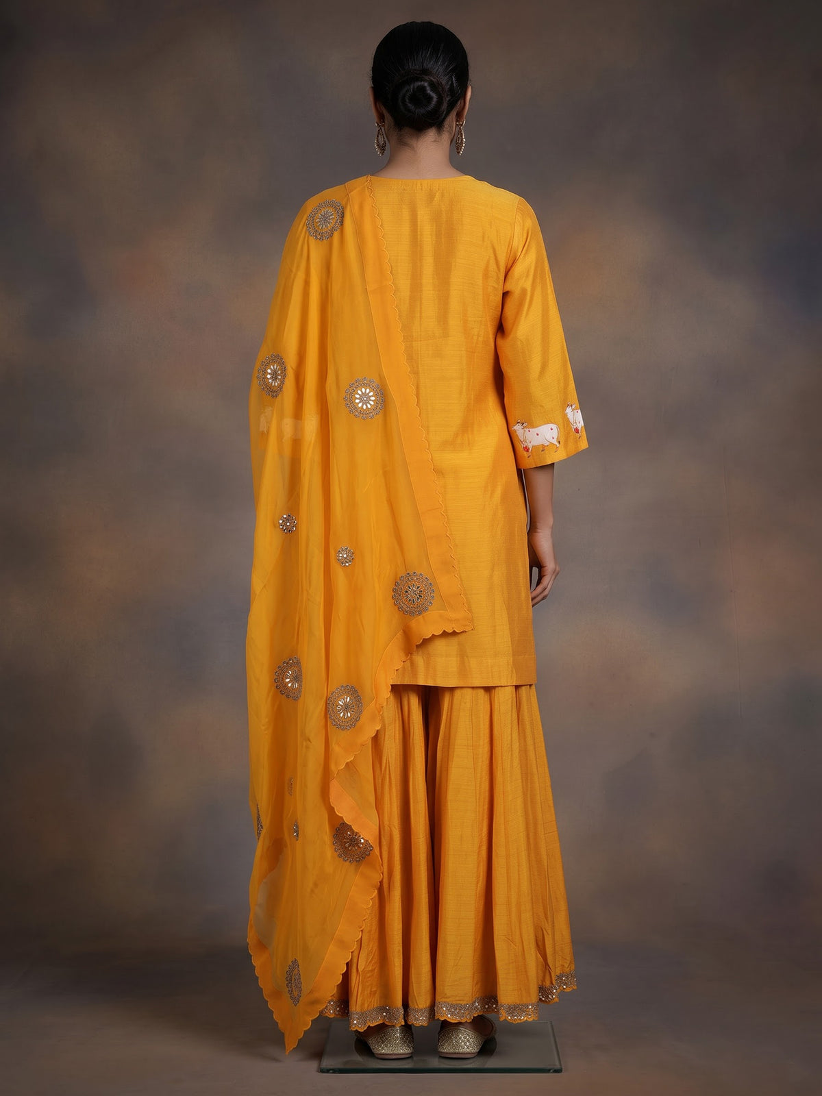 Mustard yellow silk sharara suit with animal motifs and gota work