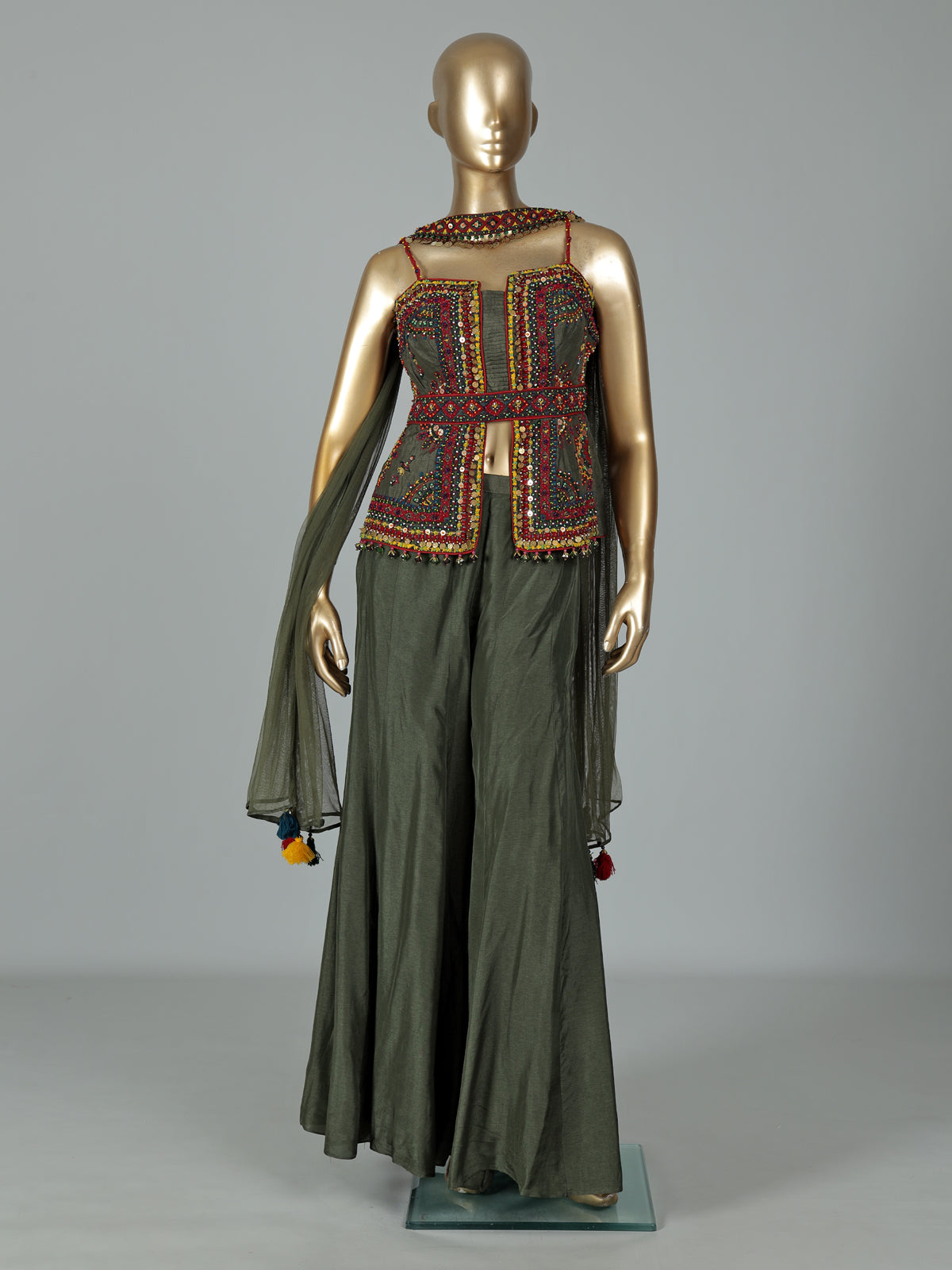 Mehendi green silk designer palazzo suit with festive tassel embellishments