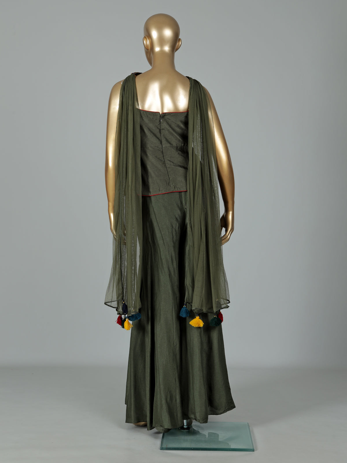 Mehendi green silk designer palazzo suit with festive tassel embellishments