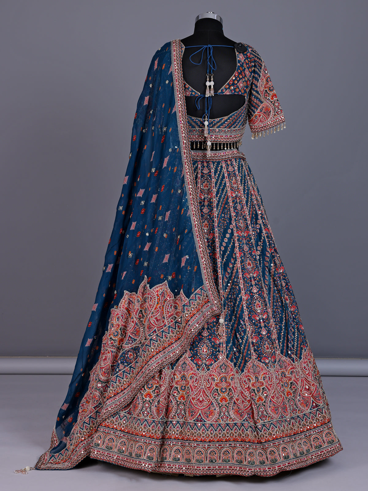 Rama blue silk lehenga choli with chevron panels and embellishments