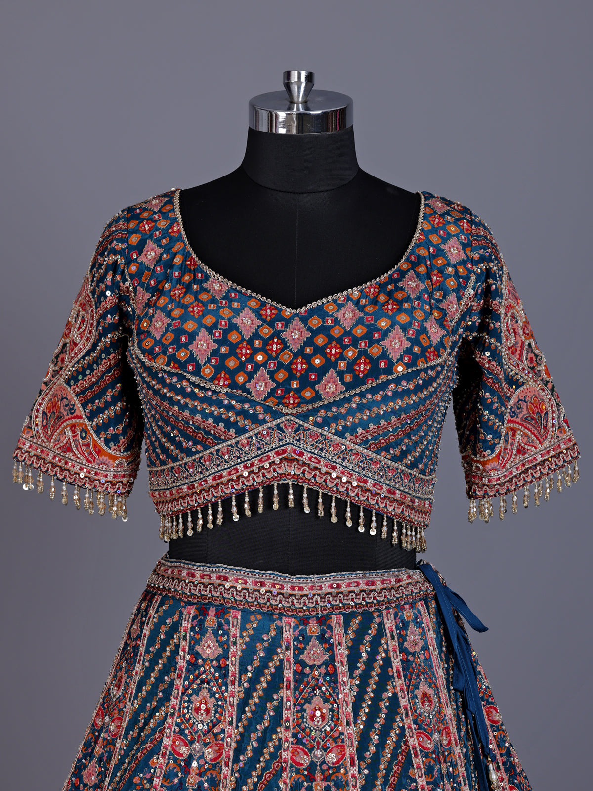 Rama blue silk lehenga choli with chevron panels and embellishments