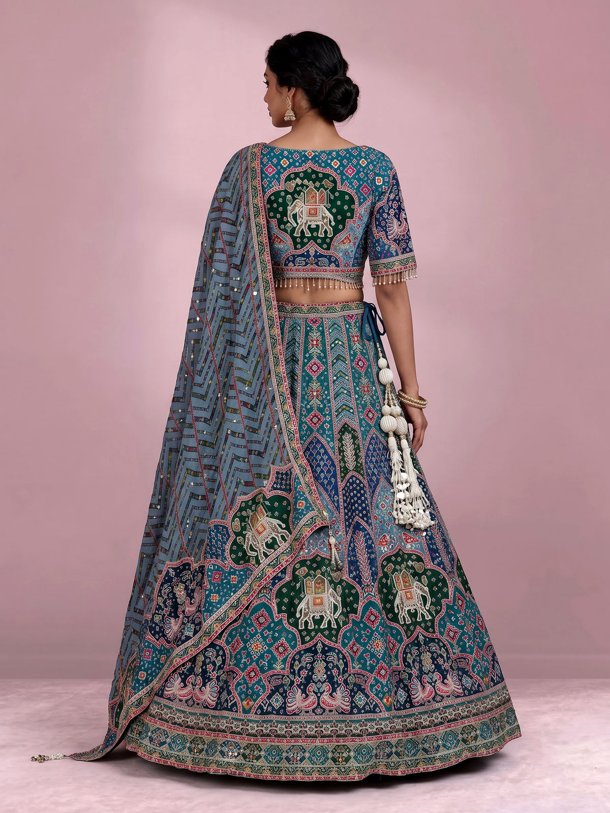 Rama green silk lehenga choli with bandhani patola detailing