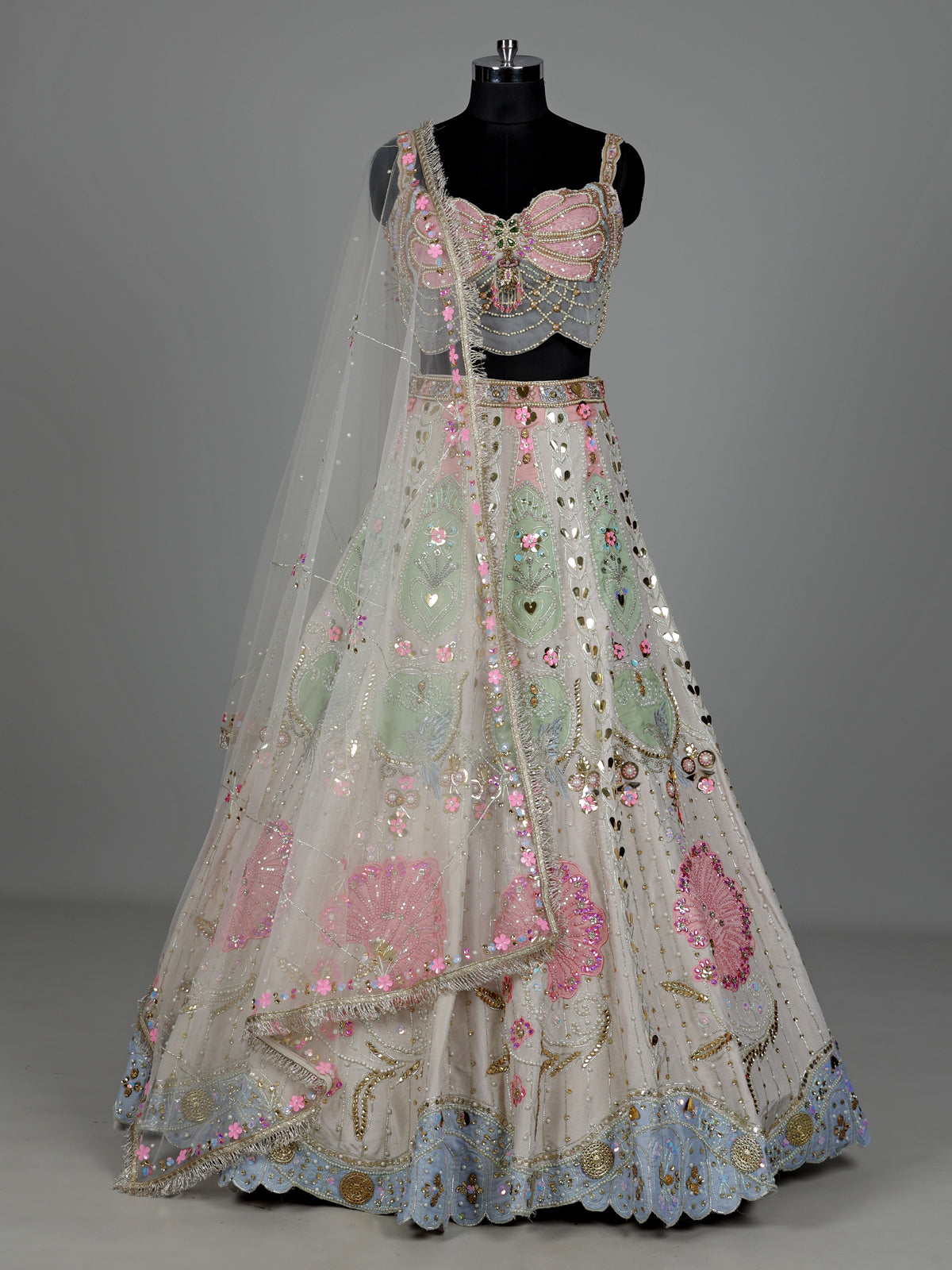 Beige silk lehenga choli with pearl and diamond embellishments