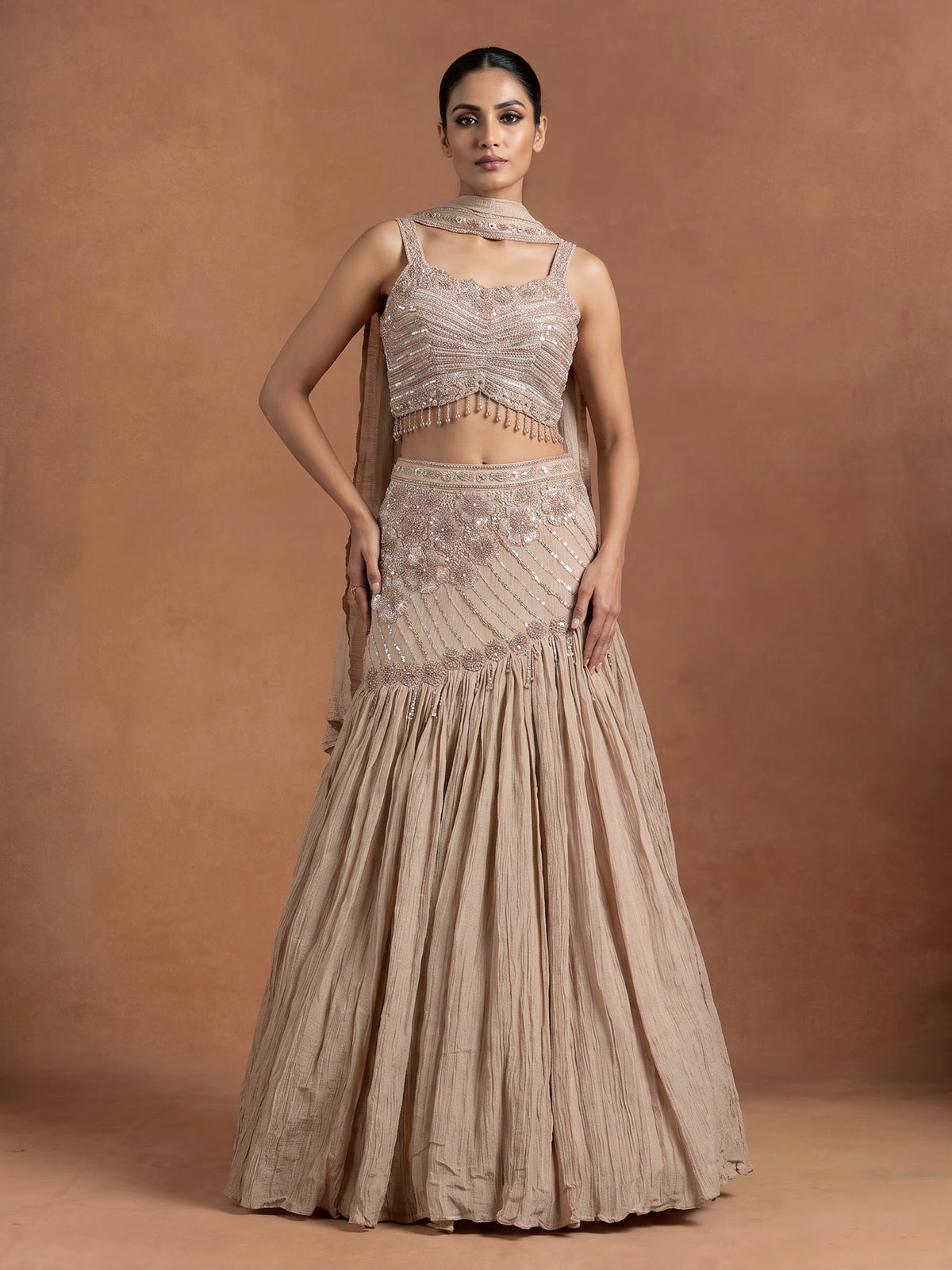 Beige chiffon silk lehenga choli with diamond and tassel detailing