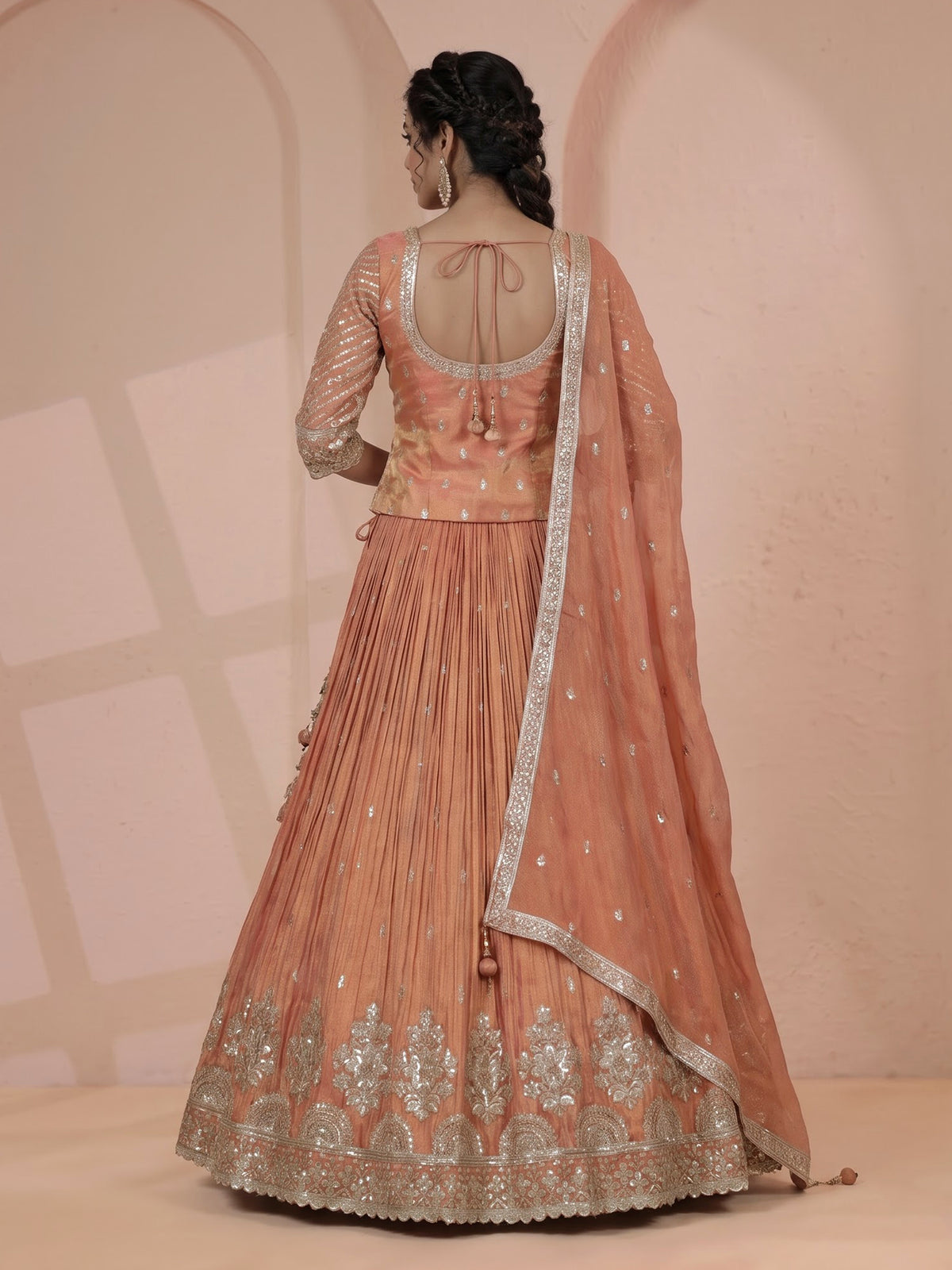 Pastel peach silk lehenga choli with elegant zardosi embroidery