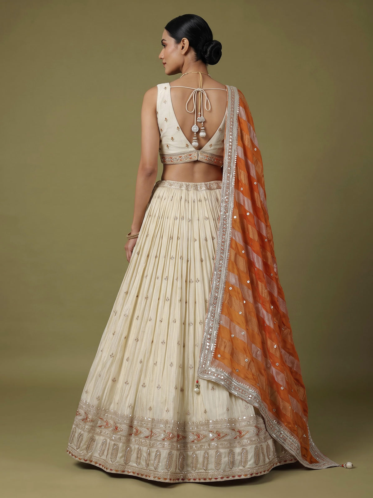 Beige silk lehenga choli with mirror work and contrast dupatta