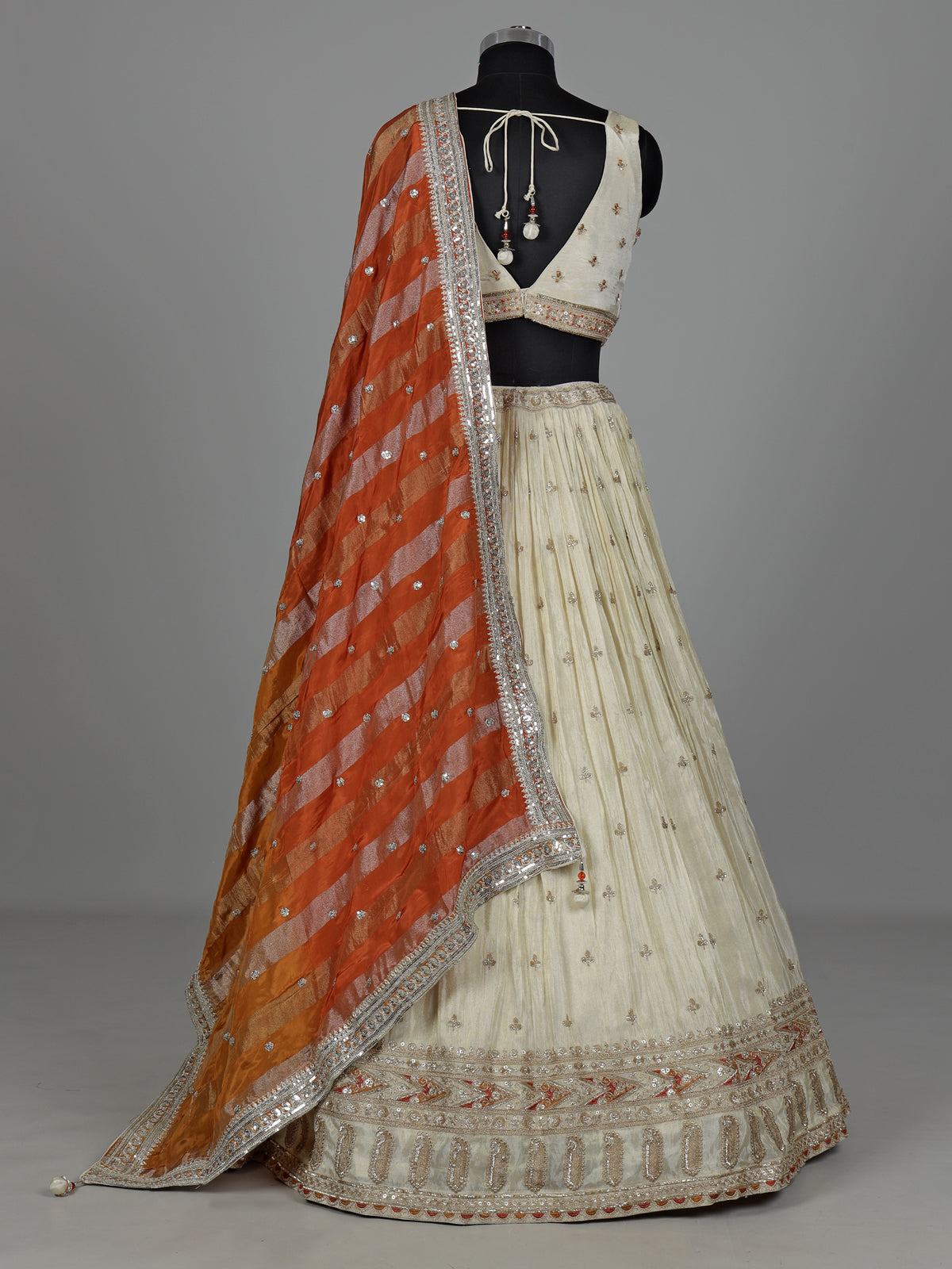 Beige silk lehenga choli with mirror work and contrast dupatta