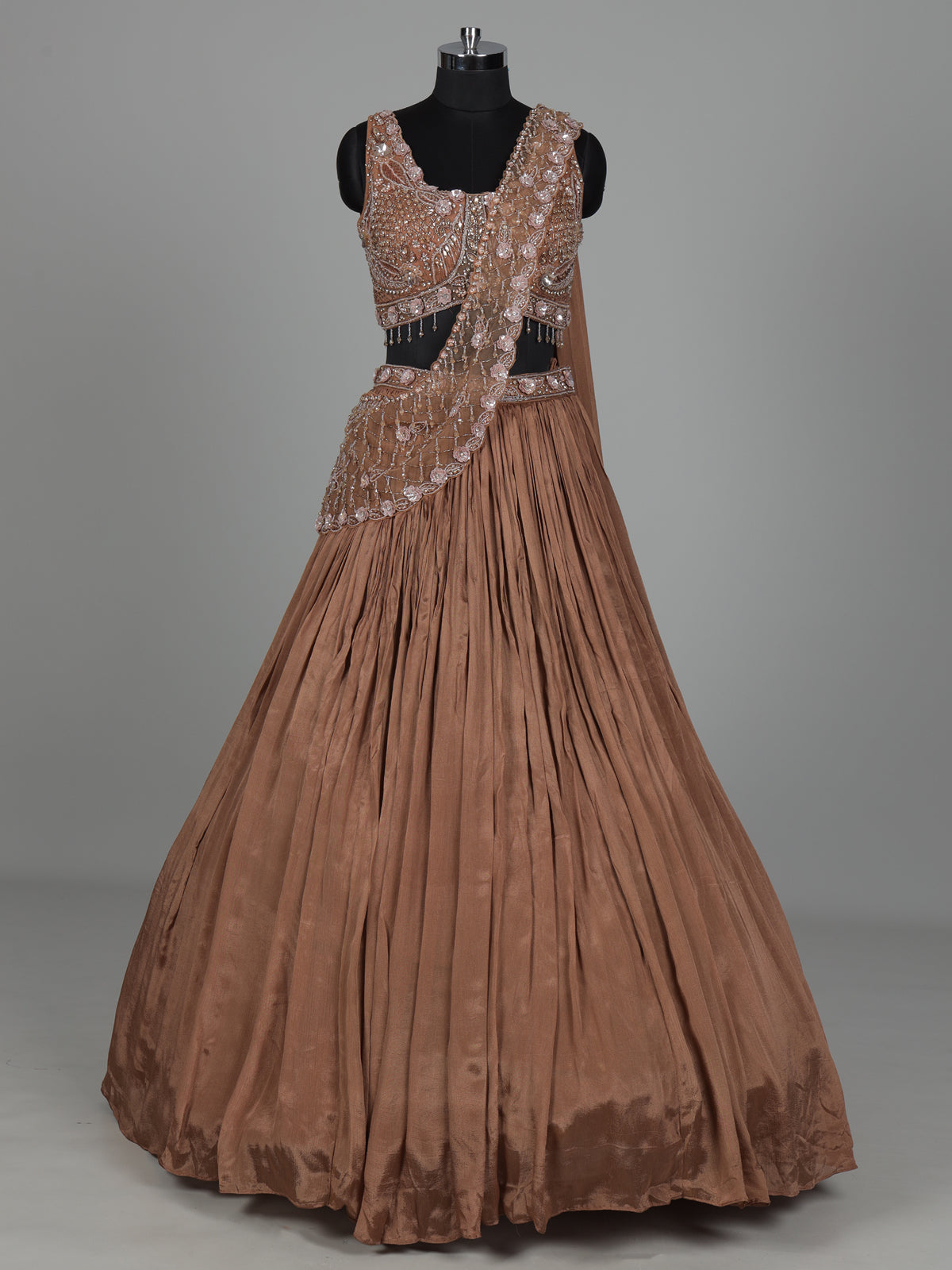 Beige chiffon silk lehenga choli with diamond and tassel accents