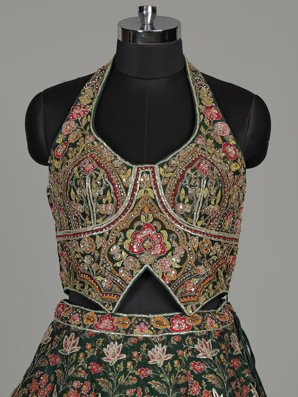 Green silk floral lehenga choli with halter neck embellishments
