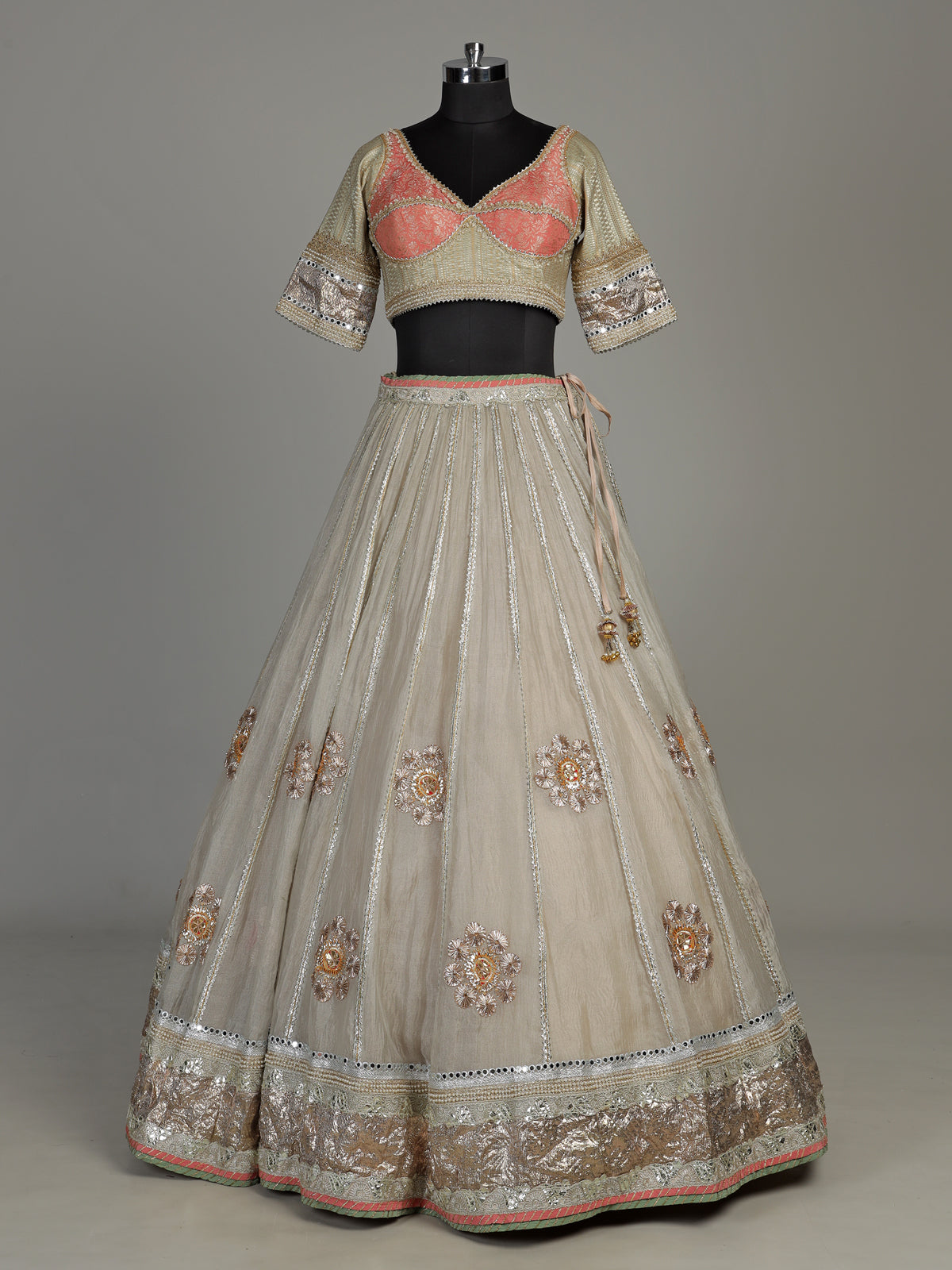 Pastel beige tissue lehenga choli with contrast dupatta embellishments