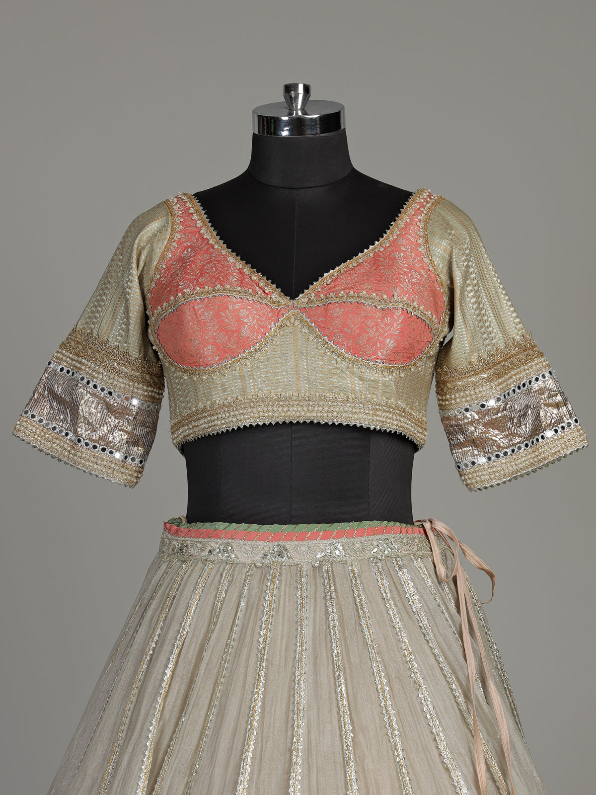 Pastel beige tissue lehenga choli with contrast dupatta embellishments