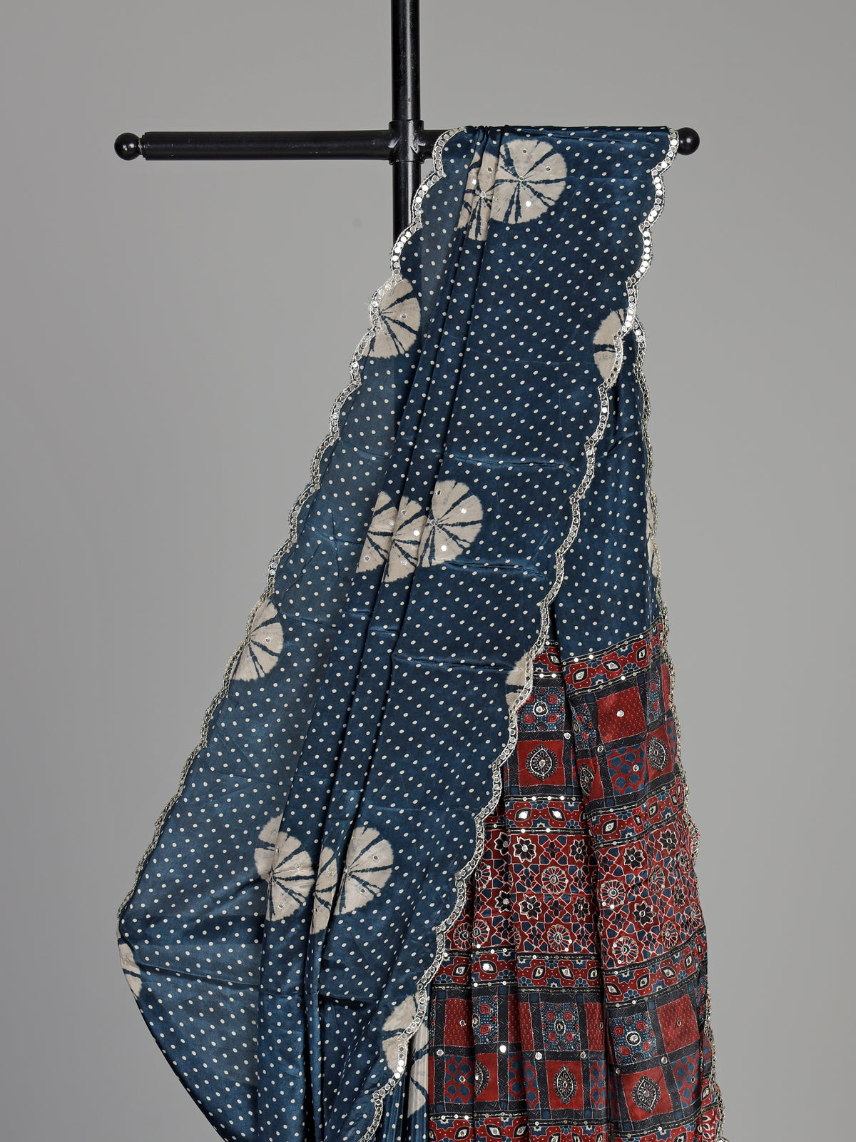 Blue crepe silk saree with printed patterns and traditional aabla work