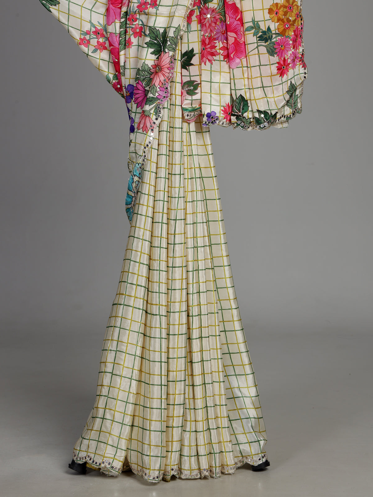 Cream crepe silk saree with checked patterns and floral embellishments