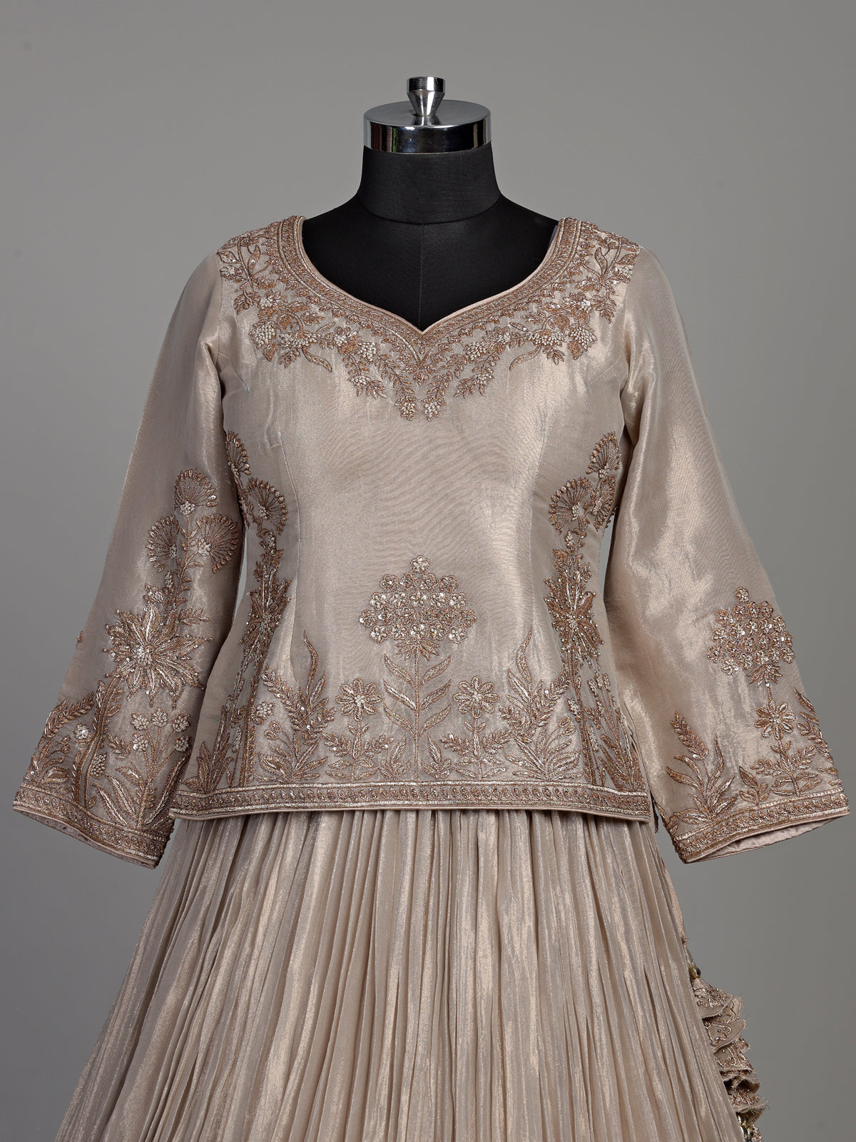 Pastel beige tissue silk lehenga choli with intricate zardosi detailing