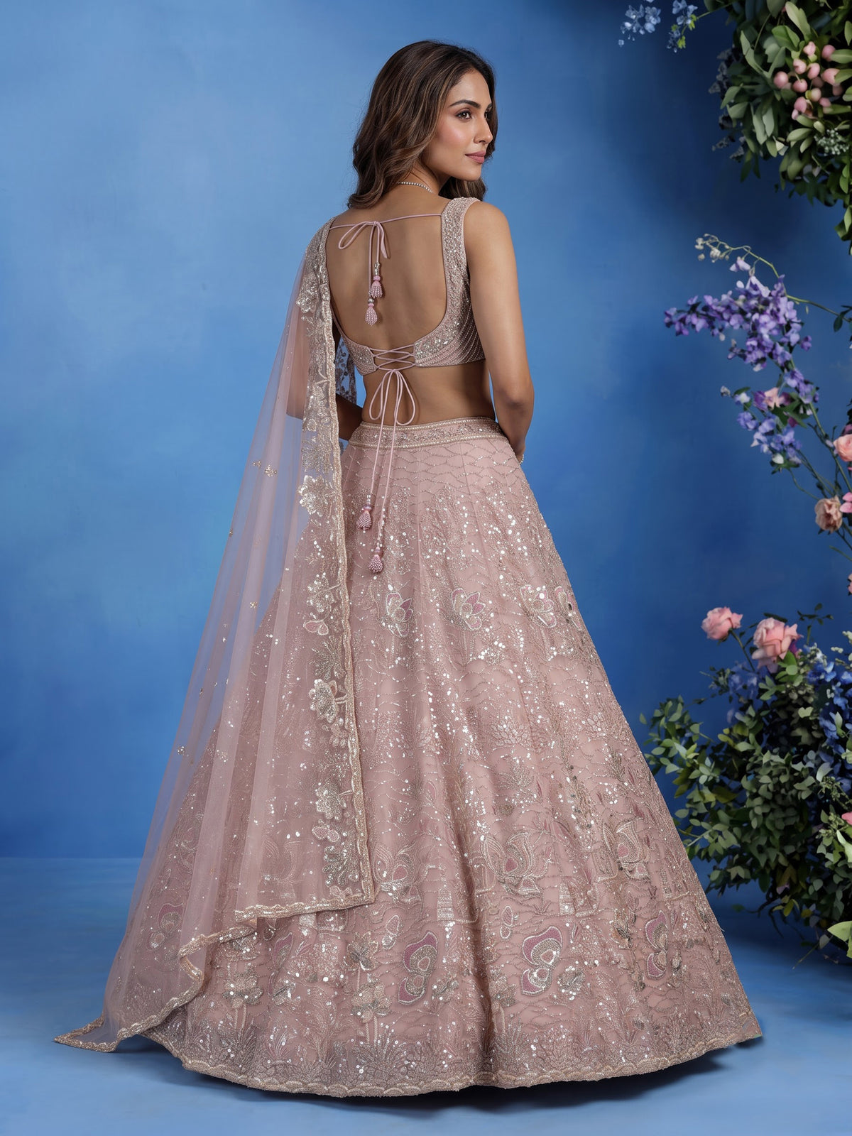Light pink net lehenga choli with cutdana and sequin embellishments
