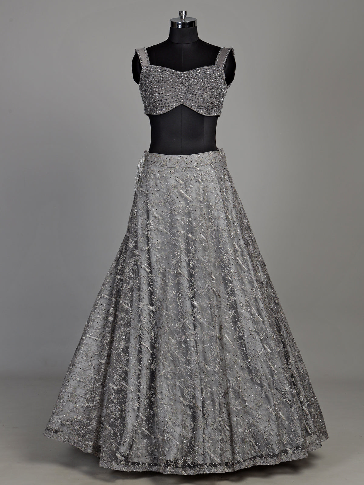 Grey net lehenga choli with pearl embellishments and designer detailing