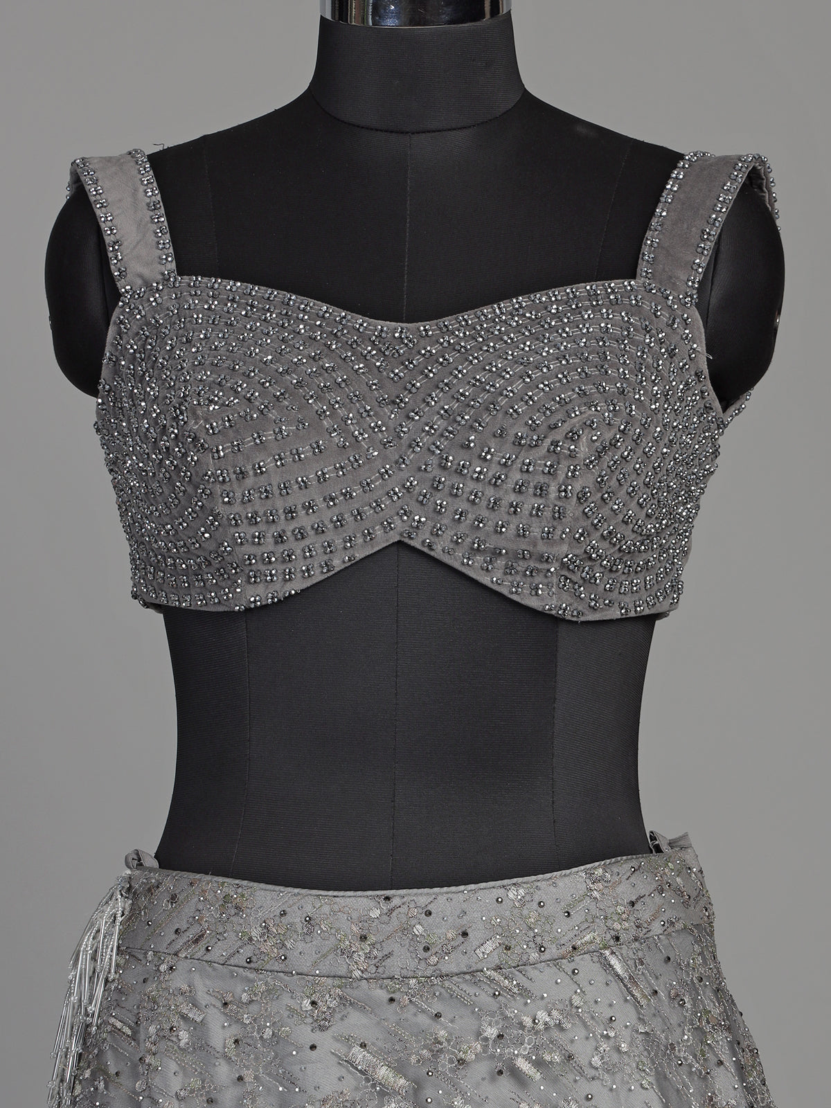 Grey net lehenga choli with pearl embellishments and designer detailing